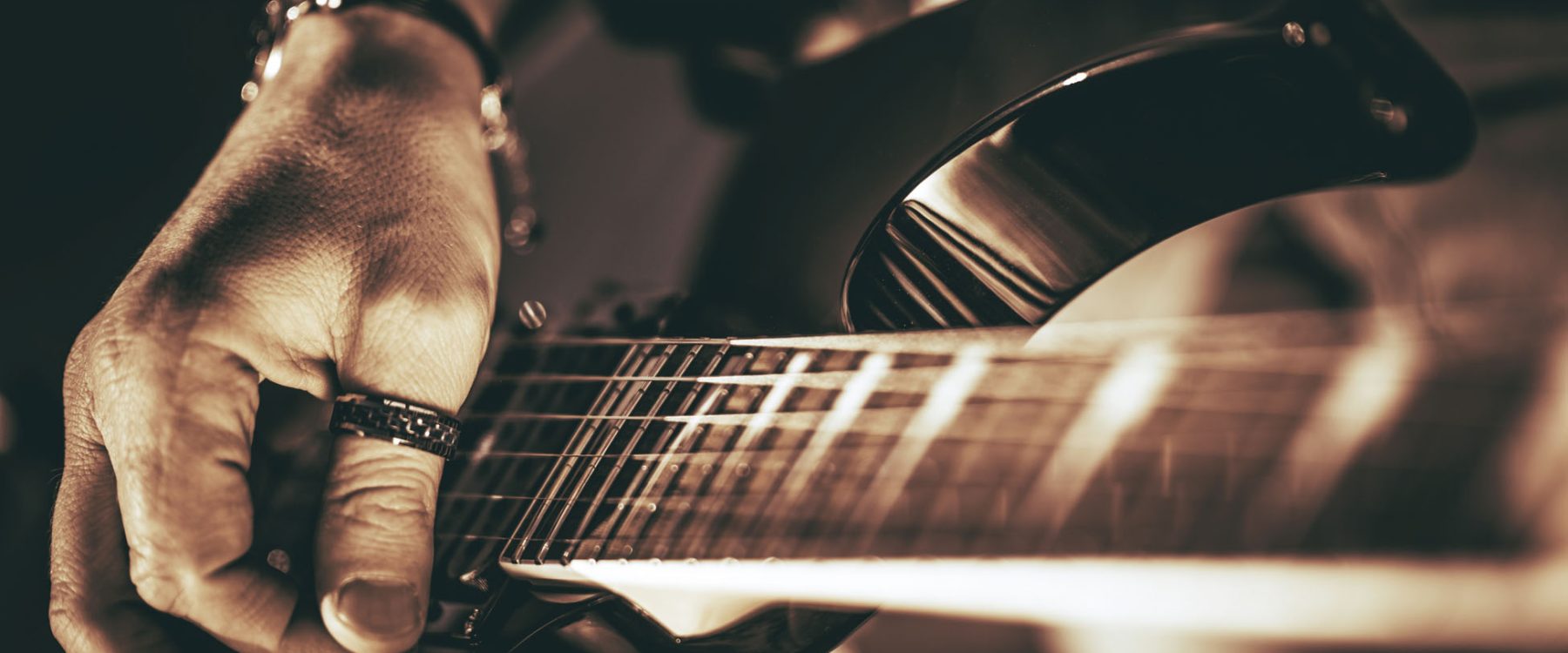 Guitarist Plays. Electric Guitar Playing Closeup Photo. Rockman Guitar Player Music Theme.